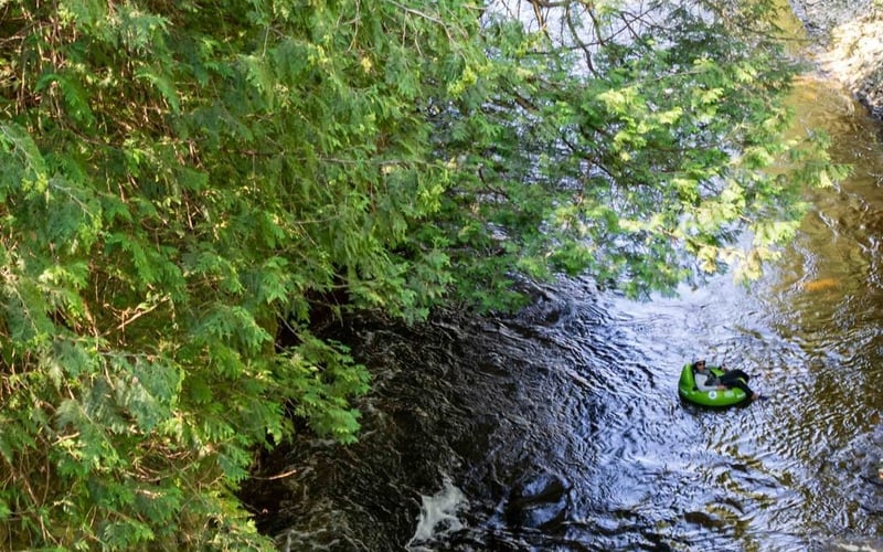 Two kayakers in narrow rocky gorge