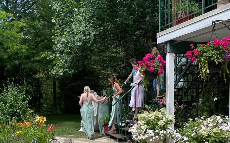 Bridesmaids on the flower-lined stairs